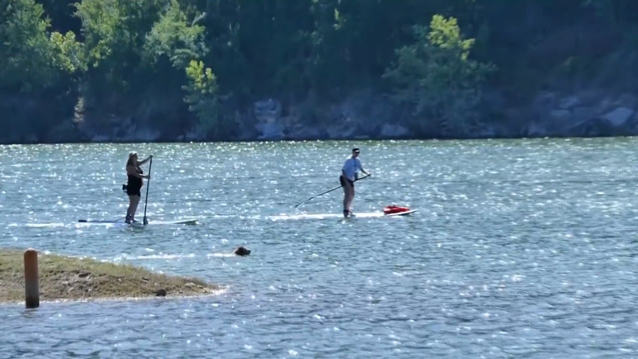 People paddle boarding near lake in Jonestown, TX